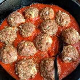 Meatballs simmering in marinara