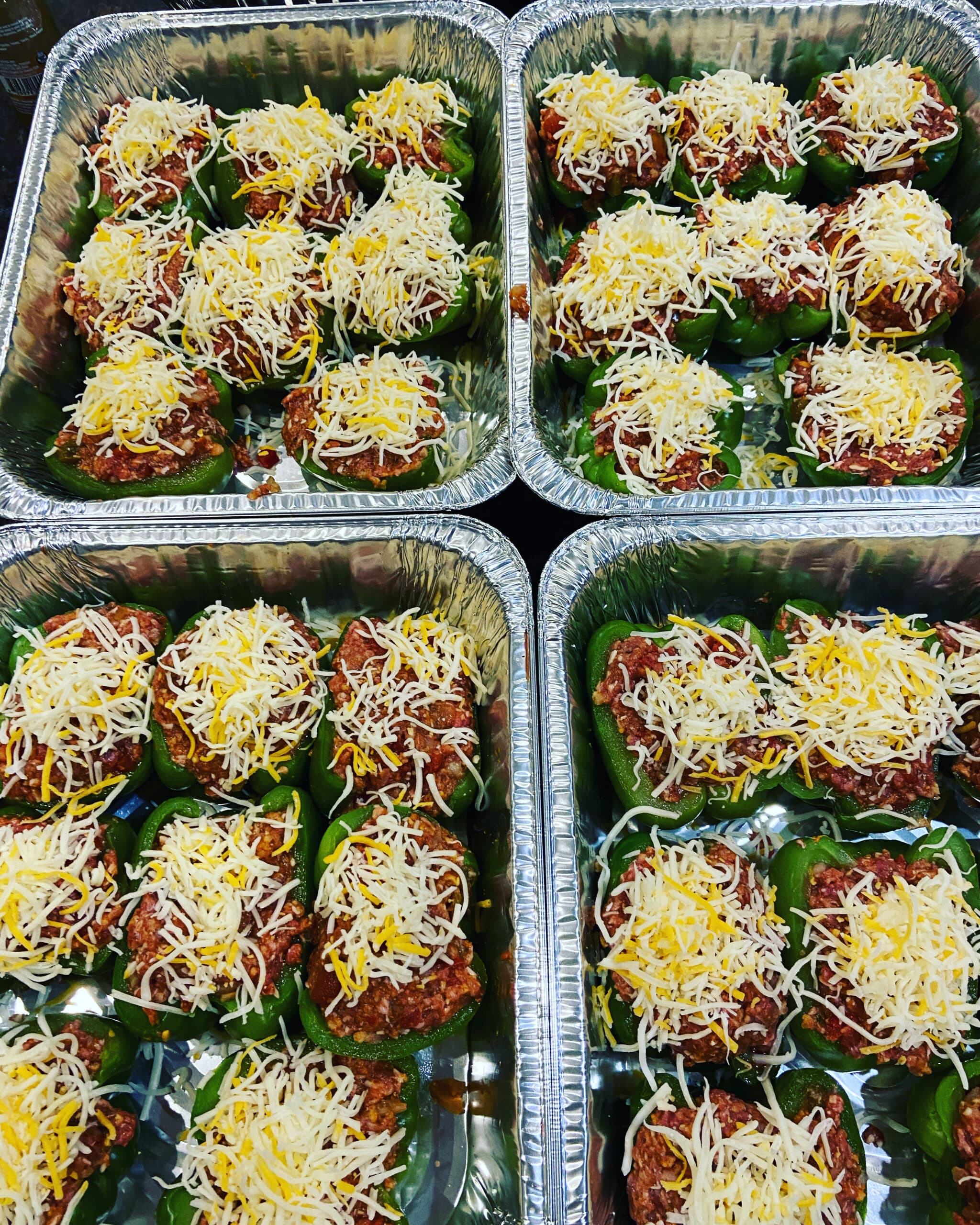 Trays of cheese-topped stuffed peppers